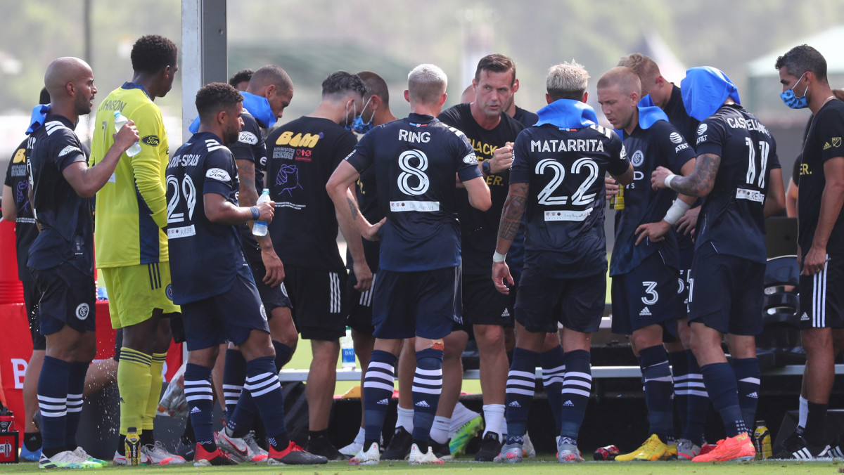 Jul 9, 2020; Kissimmee, FL, USA;  New York City FC head coach Ronny Deila talks with midfielder Alexander Ring (8), defender Ronald Matarrita (22) and teammates during the first half against the Philadelphia Union at ESPN Wide World of Sports.