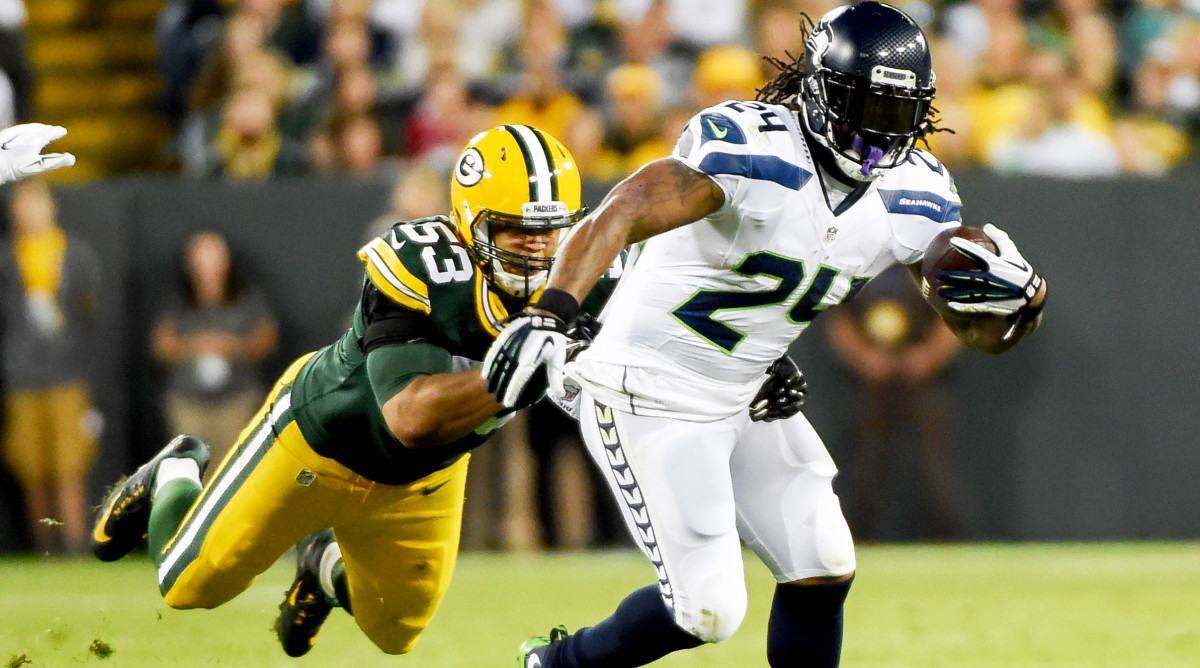 Sep 20, 2015; Green Bay, WI, USA; Seattle Seahawks running back Marshawn Lynch (24) tries to break free from Green Bay Packers linebacker Nick Perry (53) in the second quarter at Lambeau Field.