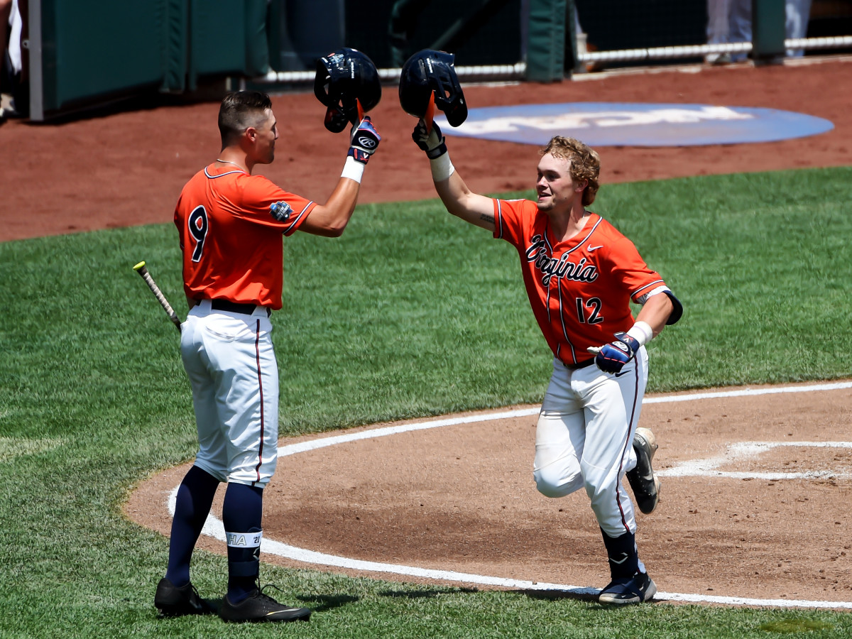 Jun 20, 2021; Omaha, Nebraska, USA; Virginia Cavaliers catcher Logan Michaels (12) celebrates with outfielder Chris Newell (9) after hitting a home run in the third inning against the Tennessee Volunteers at TD Ameritrade Park.