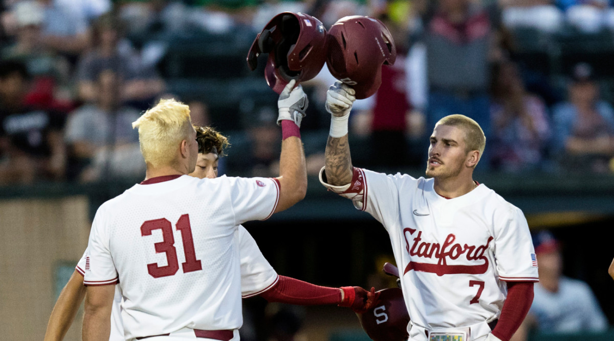 Stanford’s Brock Jones (7) celebrates with Carter Graham (31) after hitting a two-run home run against Connecticut during the second inning of an NCAA college baseball tournament super regional game Saturday, June 11, 2022, in Stanford, Calif.
