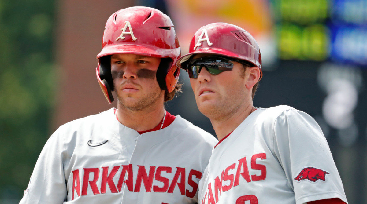 Arkansas’s Michael Turner (12) and assistant coach Bobby Wernes look toward the dugout during the second inning of an NCAA college super regional baseball game against the North Carolina in Chapel Hill, N.C., Saturday, June 11, 2022.